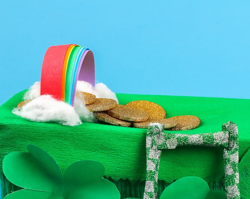 DIY leprechaun trap with gold coins, rainbow and green ladder St Patricks Day background. Gift Idea,...