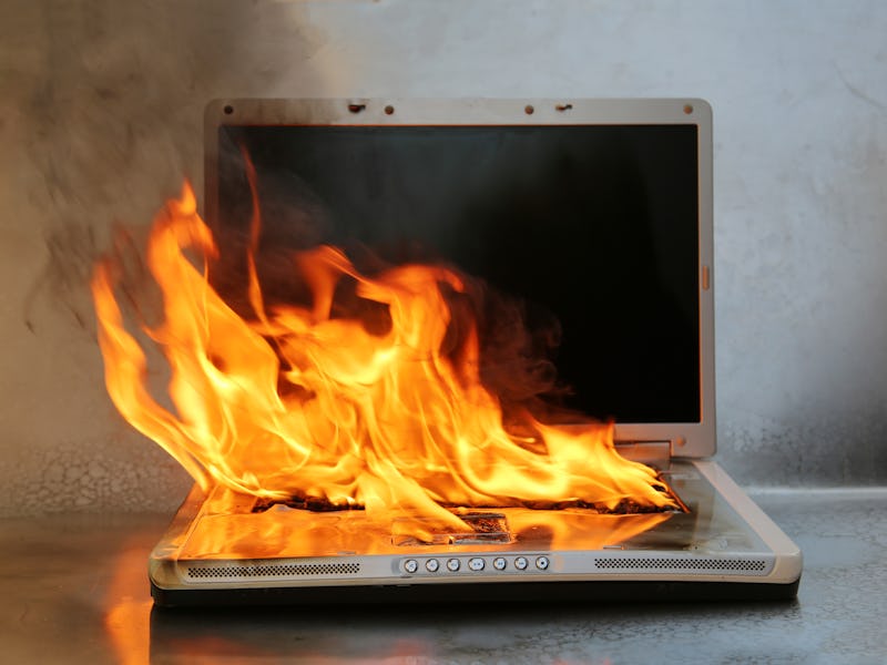 Laptop Damage. Laptop on fire and flames. Computer Repair. Flaming Fire laptop computer. 
