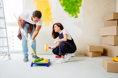 One of the best indoor date ideas is delving into a home improvement project, like painting a wall.