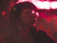 Girl with glasses in neon red lights