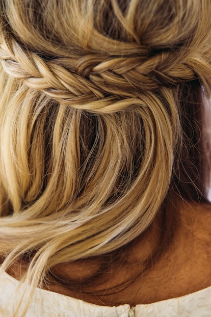 A cuacasian blonde woman close up of her braided hair.