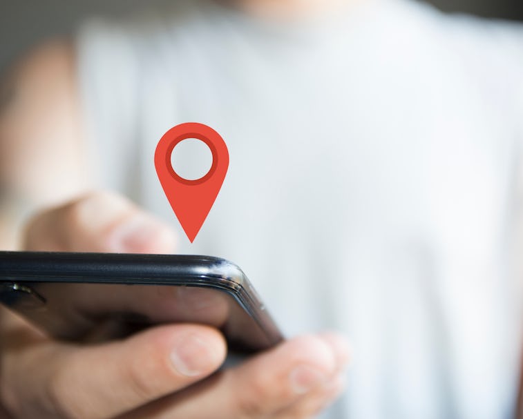 digital composite of person holding phone location icon