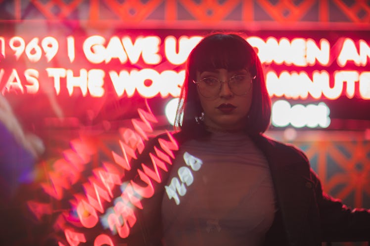 Girl with glasses in neon red lights