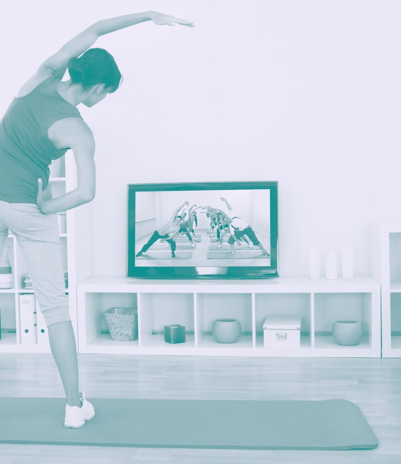 Female Doing Fitness Exercise In Front Of Television