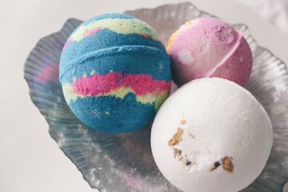 Bath bombs in grey tray against white background