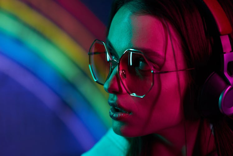 colored portrait of a beautiful young girl in neon light 
