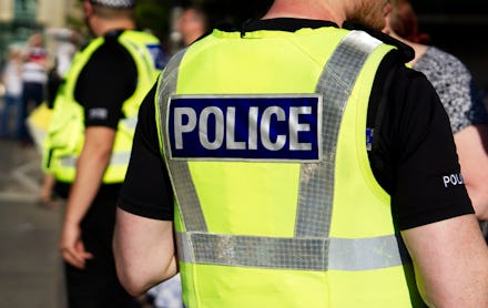 Police officer on duty on a city centre street during special event.