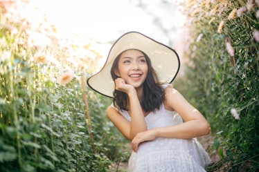 outdoor portrait of a beautiful asia woman. attractive cute girl in a field with flowers