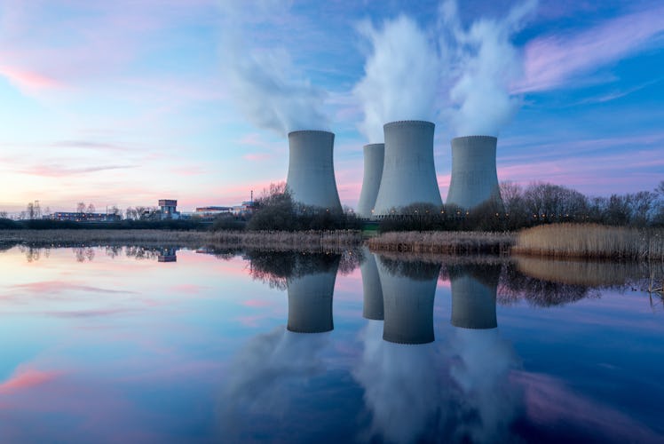 Nuclear power plant after sunset. Dusk landscape with big chimneys.