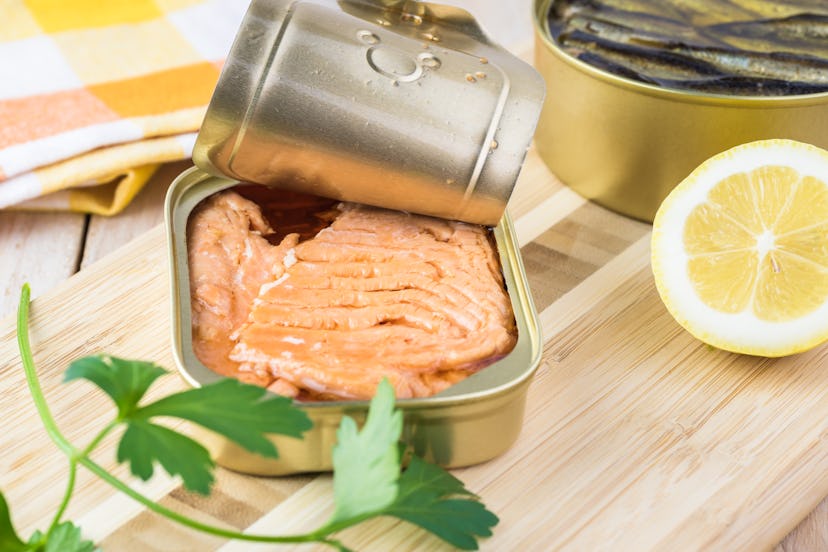 Open  canned fish. Tin can with smoked salmon fillets.