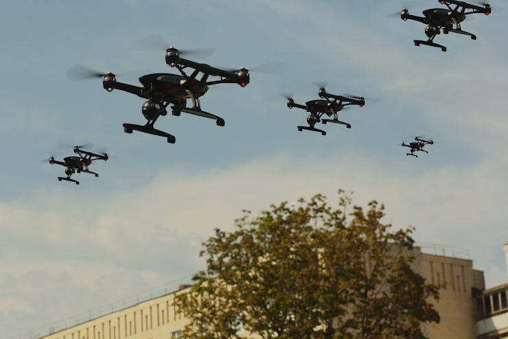 Swarm of Quadcopters Drones In The Air Over City. Army invasion