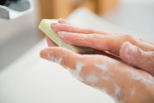 Closeup on young woman hands with soap bar
