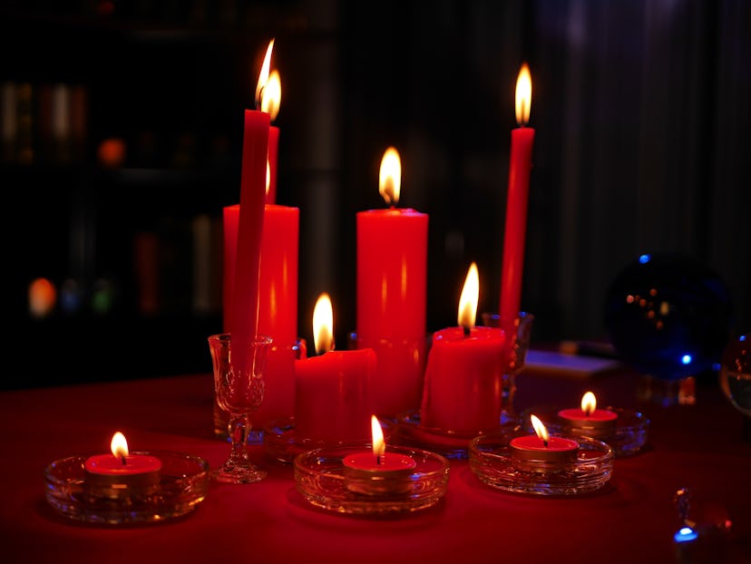 Mystical dark scenes of red burning candles for occult  divine magic for better luck for Chinese new...