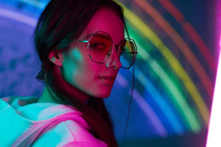 colored portrait of a beautiful young girl in neon light 
