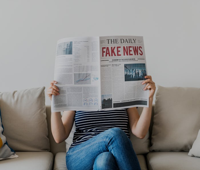 Woman reading newspaper