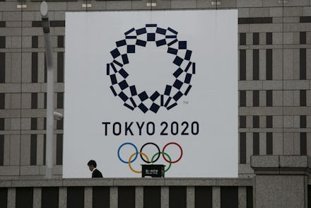 Man walks past a large banner promoting the Tokyo 2020 Olympics in Tokyo, . The IOC will take up to ...
