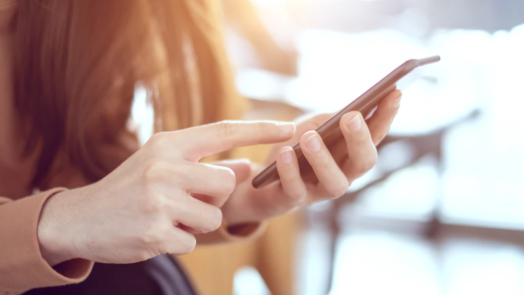 Close up woman hand holding smartphone, She using in mobile applications and multimedia programs. copy space