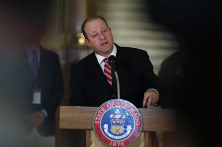 Graph, Colorado Gov. Jared Polis makes a point during a news conference about the state's efforts to...