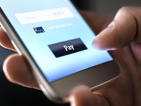 Mobile payment with wallet app and wireless nfc technology. Man paying and shopping with smartphone ...