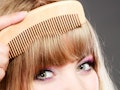 Fashion beauty and haircare concept. Closeup young woman refreshing her hairstyle girl combing her h...