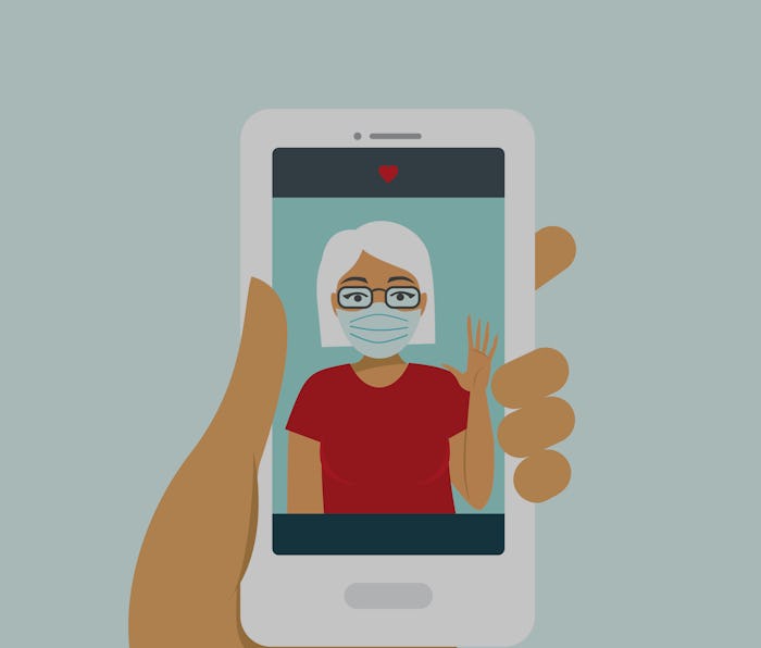 Human hand holding smart phone video call on the screen with your elderly family member, mother, gra...