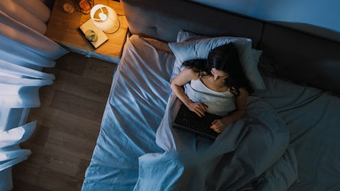 Top View Young Woman in Bed Working on a Laptop Computer at Night. Student Getting Ready to Exams, E...