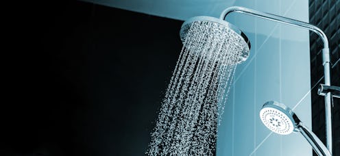 Close up of Water flowing from shower in the bathroom interior