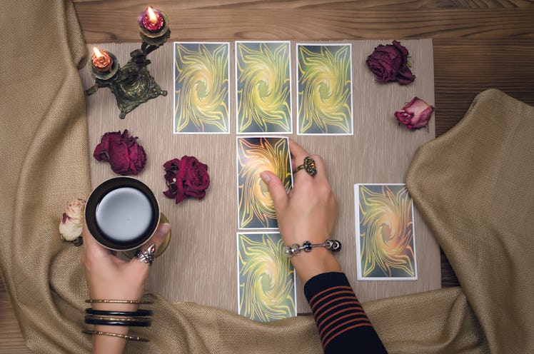 Tarot cards on wooden desk table of fortune teller. Tarot reading.