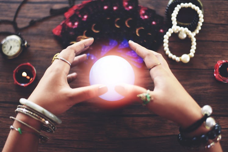 Psychic readings and clairvoyance concept / Crystal ball fortune teller hands and Tarot cards readin...