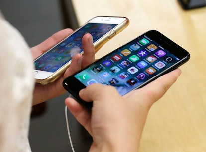 Lisa Gao compares a new jet black iPhone 7, right, with her iPhone 6 at the Apple Store in Chicago. ...