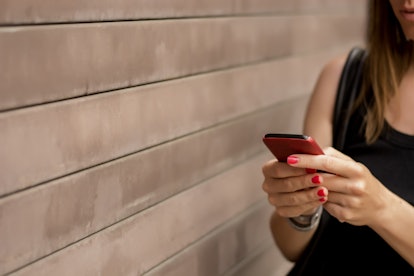 Woman text messaging on mobile phone