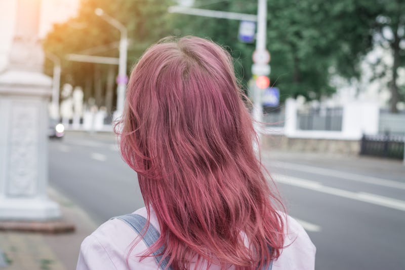 Hipster woman pink head back view, city street