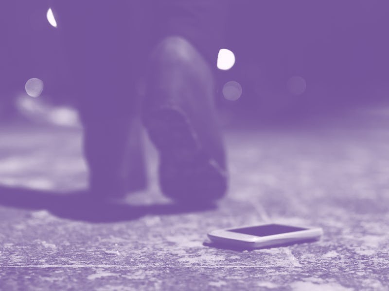 Lost mobile phone dropped from a woman pocket on the night footpath and is walking away silhouette o...