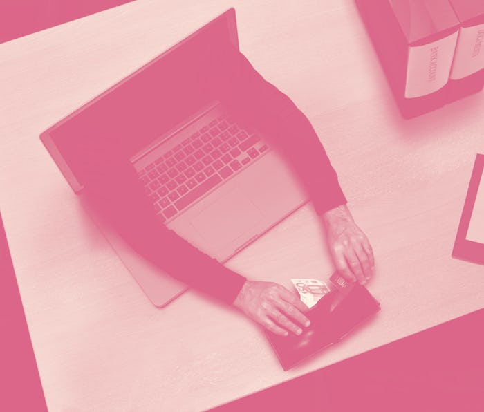 hacker cyber criminal stealing a credit card data , money and documents from laptop screen