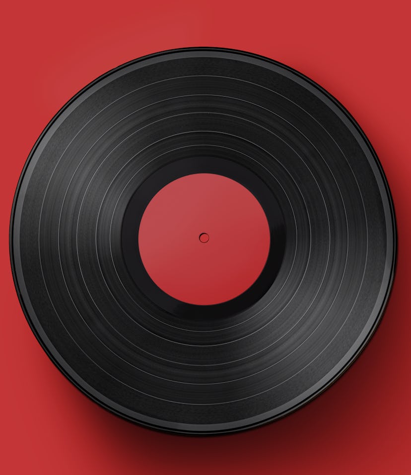 Vinyl record on a colored background. Old vintage vinyl record isolated