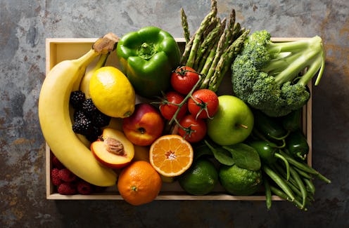 Fresh and colorful vegetables and fruits in a wooden crate