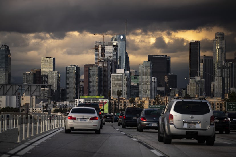 People drive through downtown in a light traffic as California Governor Gavin Newsom and Los Angeles...