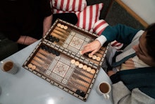 Roommates of Susanne Hassler-Smith and Thomas Smith play a board game in their shared flat in Vienna...