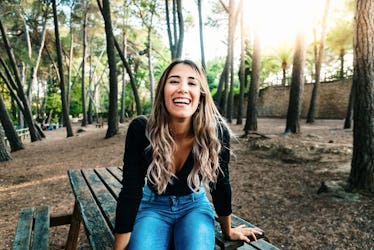 Beautiful teenage girl laughing out loud full of life and happiness when leaving high school.