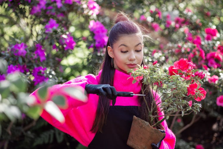 happy girl with a flower and scissors in her hands