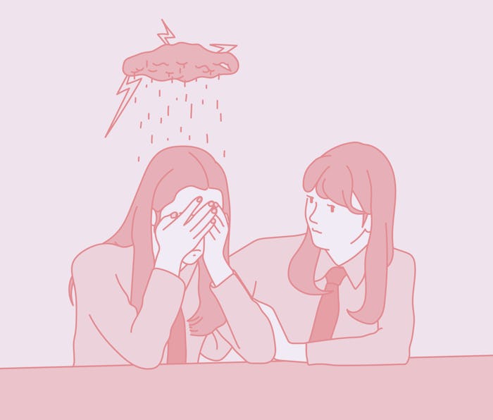 A schoolgirl covers her face with her hands and weeps, and a friend is comforting her next to her. h...