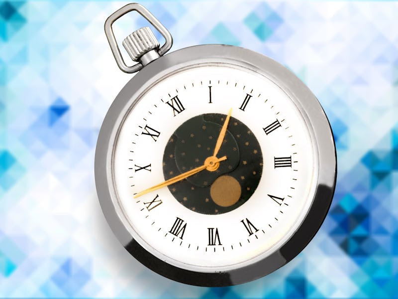 The classic silver clock on abstract background