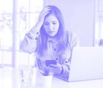 Beautiful young woman using smartphone and computer stressed with hand on head, shocked with shame a...