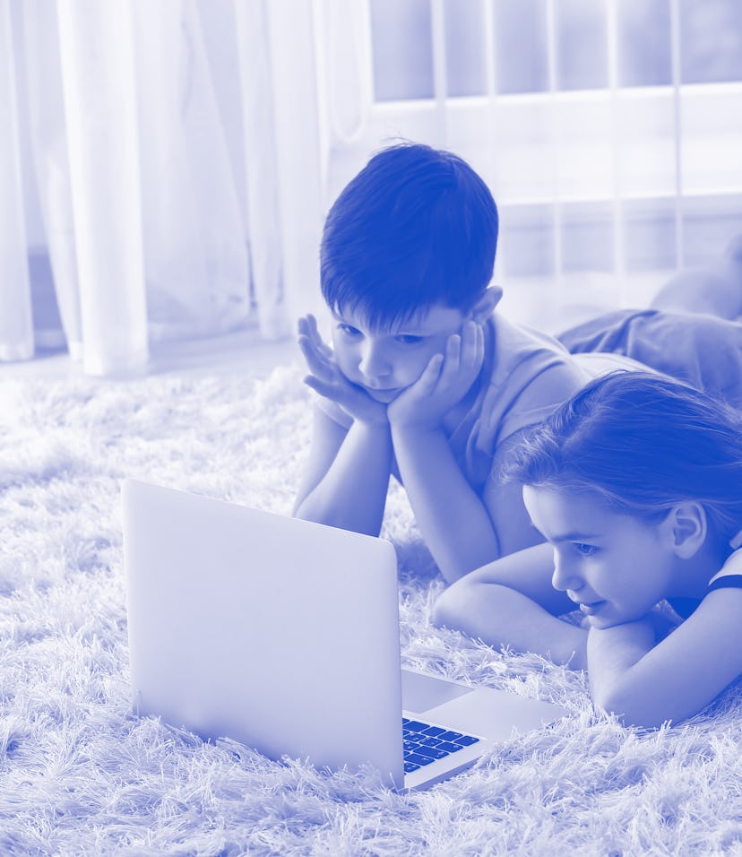 Cute little children with laptop watching cartoons at home