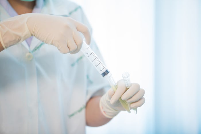 a doctor holding an amniocentesis syringe