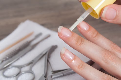 Apply oil to the cuticle. Manicure, nail care. Nail salon, procedure, SPA. Home nail care. Manicure ...