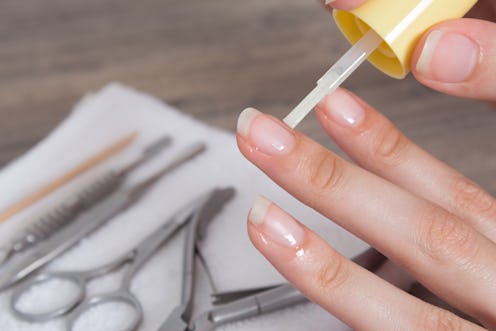 Apply oil to the cuticle. Manicure, nail care. Nail salon, procedure, SPA. Home nail care. Manicure ...