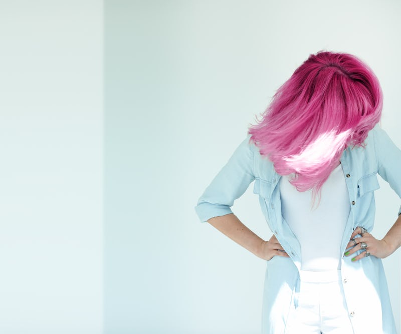 Motion shot of woman's hair. Dyed hair in daylight concept. 