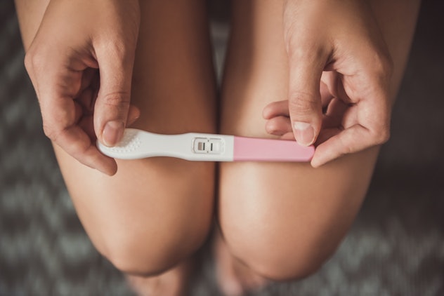 woman holding a positive pregnancy test