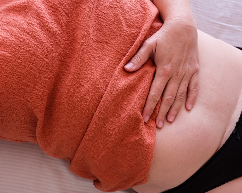 woman holding her stomach after c section